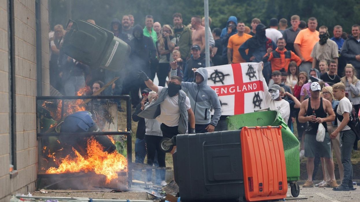 Demonstrators toss a trash bin during an anti-immigration protest, in Rotherham, Britain, August 4, 2024.
