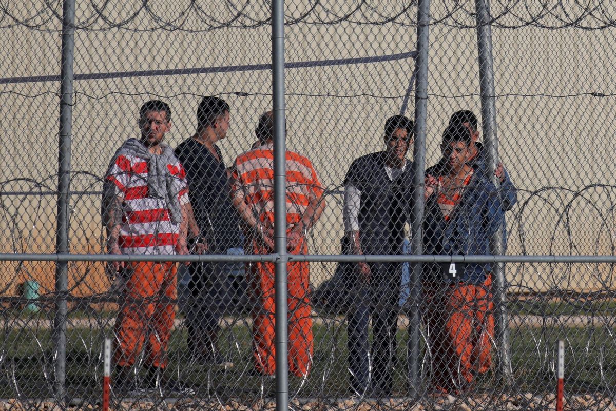 ​Detainees stand behind a fence at the Bluebonnet Detention Facility, where Venezuelans at the center of a Supreme Court ruling on deportation are held, in Anson, Texas, U.S. April 22, 2025.  