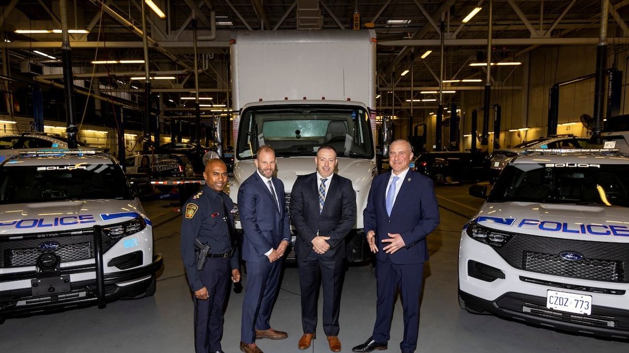 Detectives pose in front of the truck used in the Toronto Pearson International Airport gold heist as they give details of the arrests made one year on in Brampton, Ontario, on April 17, 2024.