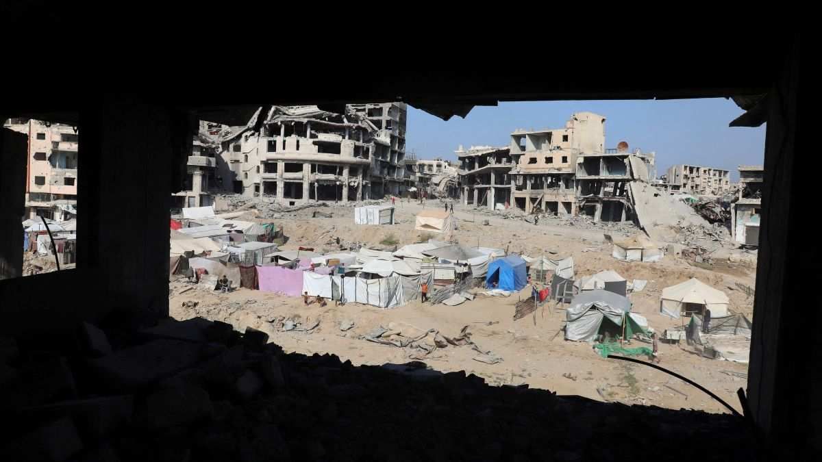 ​Displaced Palestinians live in tents near destroyed buildings in Gaza City, on October 19, 2025.