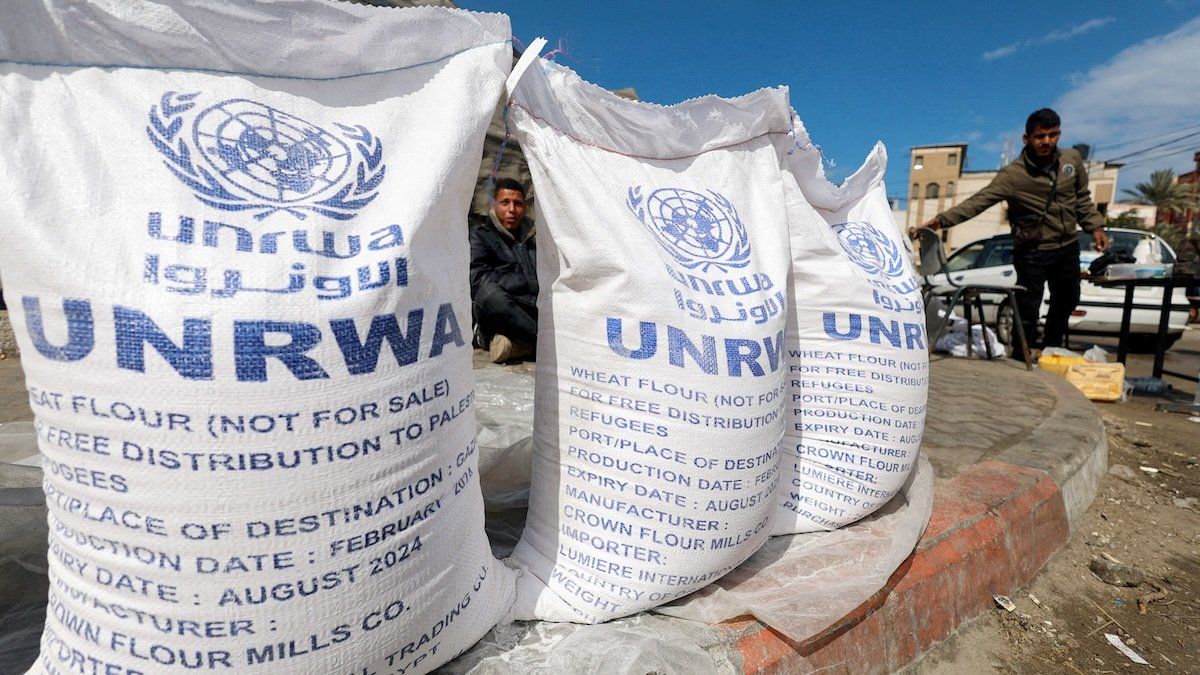 ​Displaced Palestinians wait to receive UNRWA aid amid the ongoing conflict between Israel and Hamas, in Rafah, in the southern Gaza Strip, March 7, 2024.