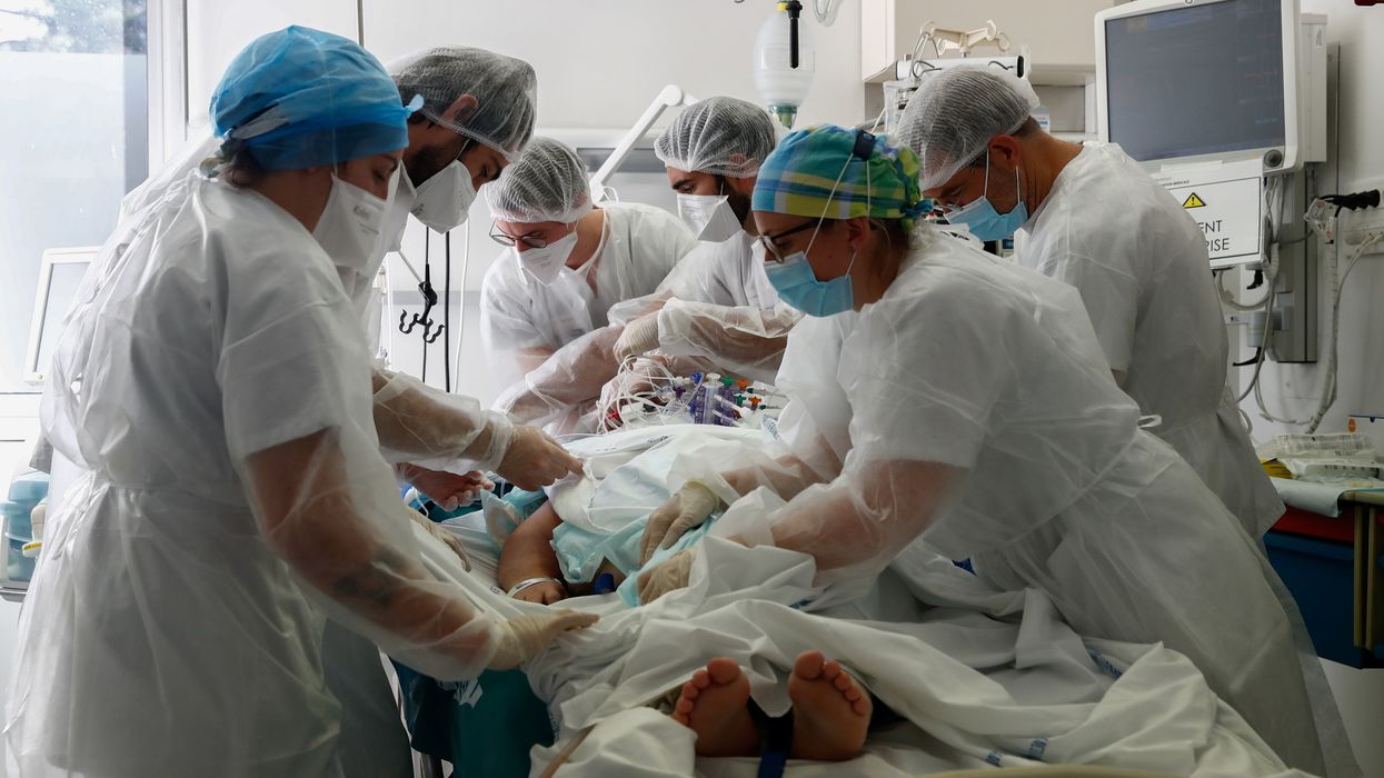 Doctor and medical colleagues treat a patient suffering from COVID-19 in the Intensive Care Unit (ICU) at the Robert Ballanger hospital near Paris during the outbreak of the coronavirus disease in France, October 26, 2020