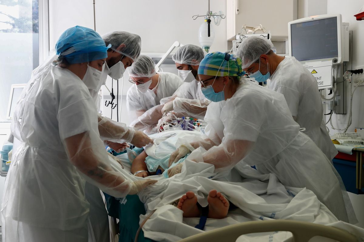 Doctor and medical colleagues treat a patient suffering from COVID-19 in the Intensive Care Unit (ICU) at the Robert Ballanger hospital near Paris during the outbreak of the coronavirus disease in France, October 26, 2020