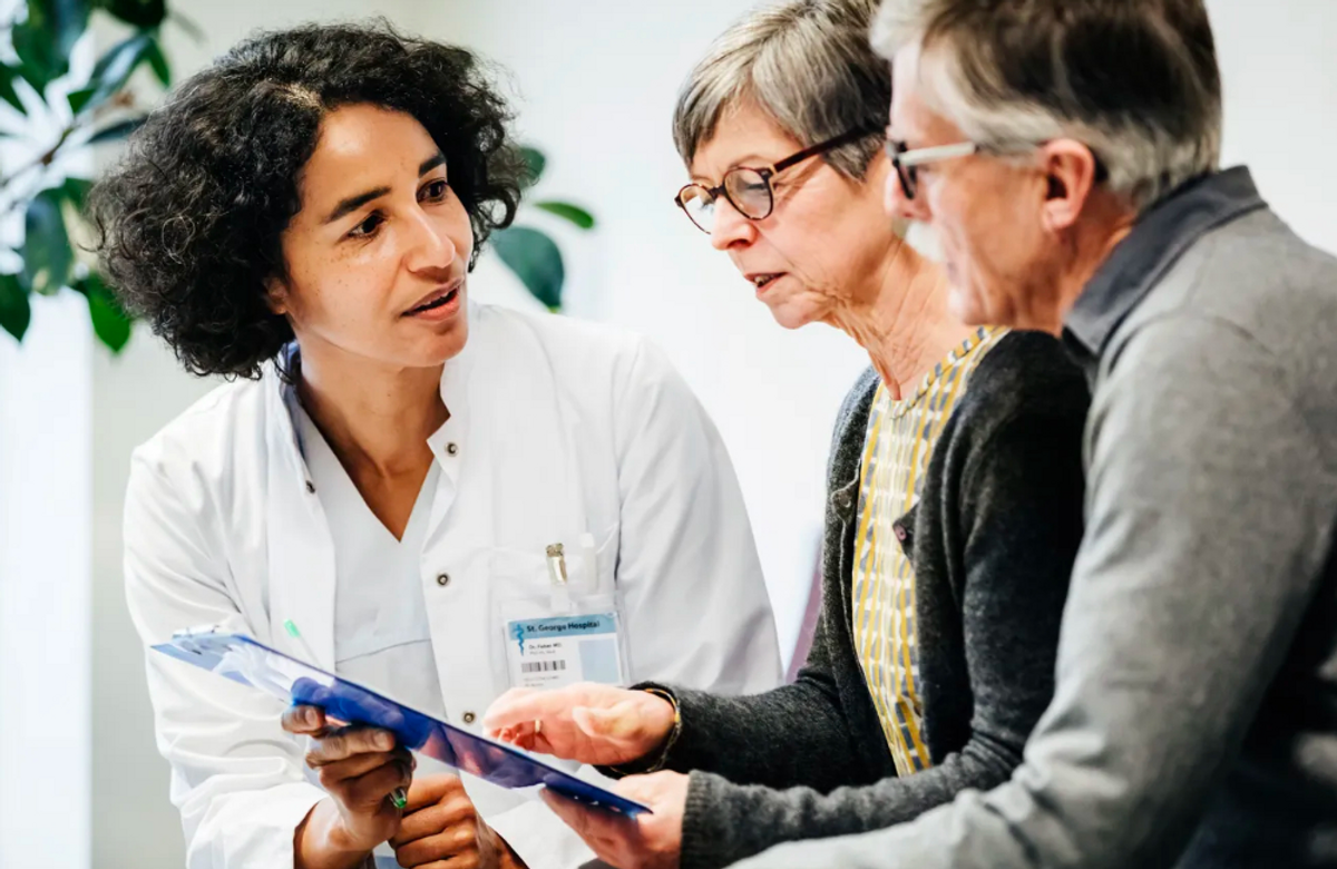Doctor conversing with an older couple