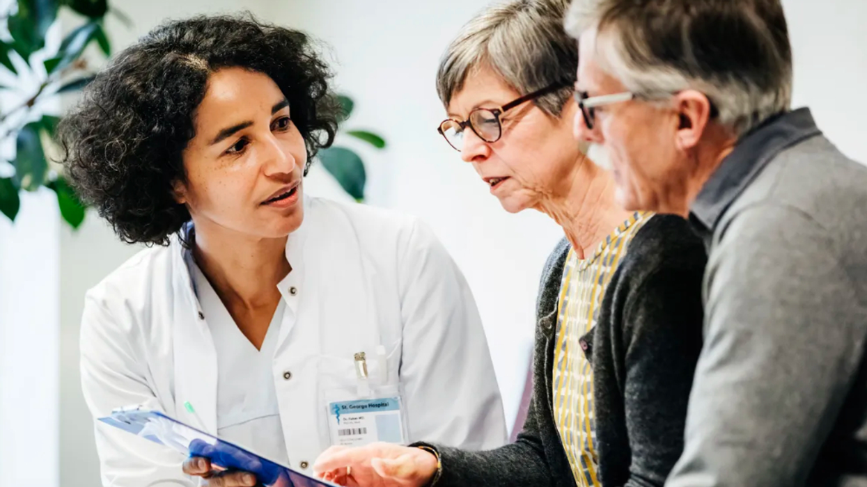 Doctor conversing with an older couple