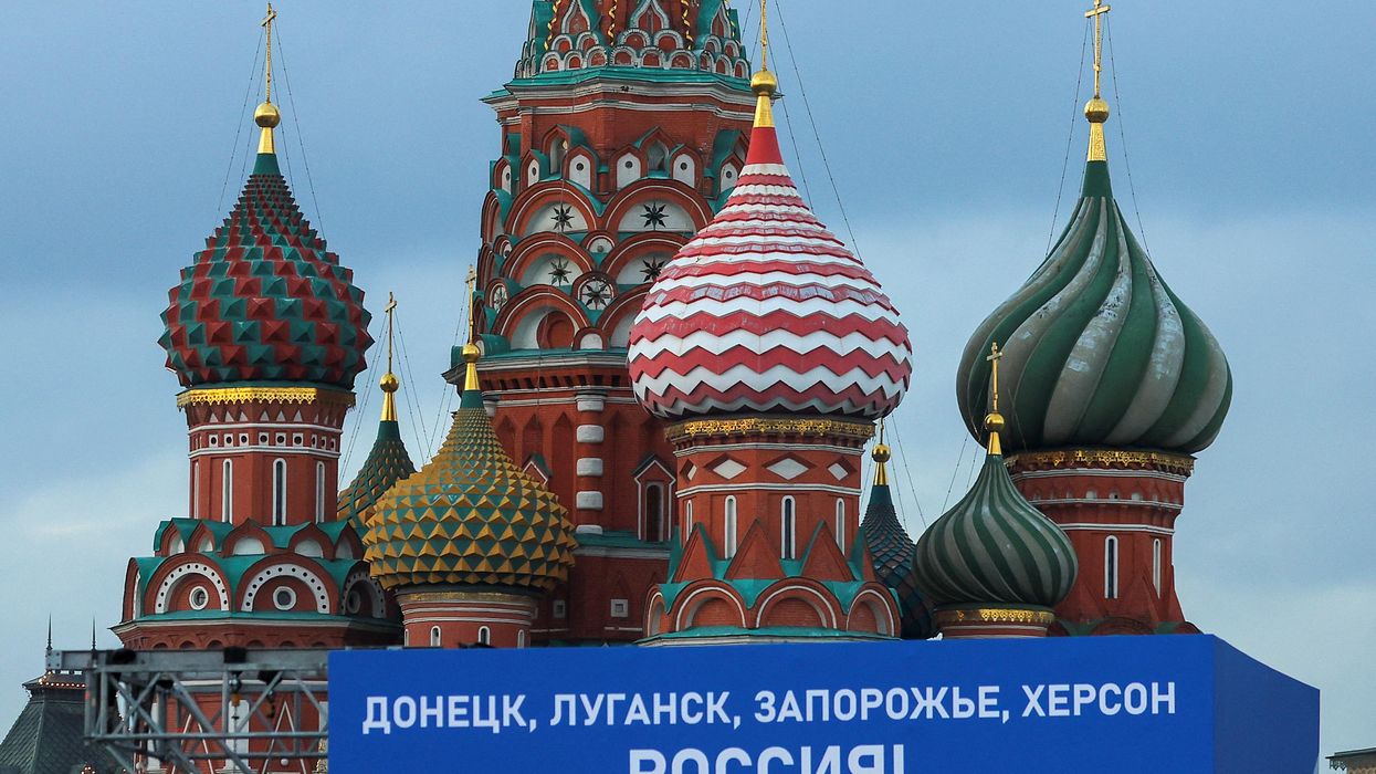 "Donetsk, Luhansk, Zaporizhzhia, Kherson - Russia!" A banner on a screen set up ahead of an expected ceremony and concert in Moscow to declare four Ukrainian regions part of Russia.