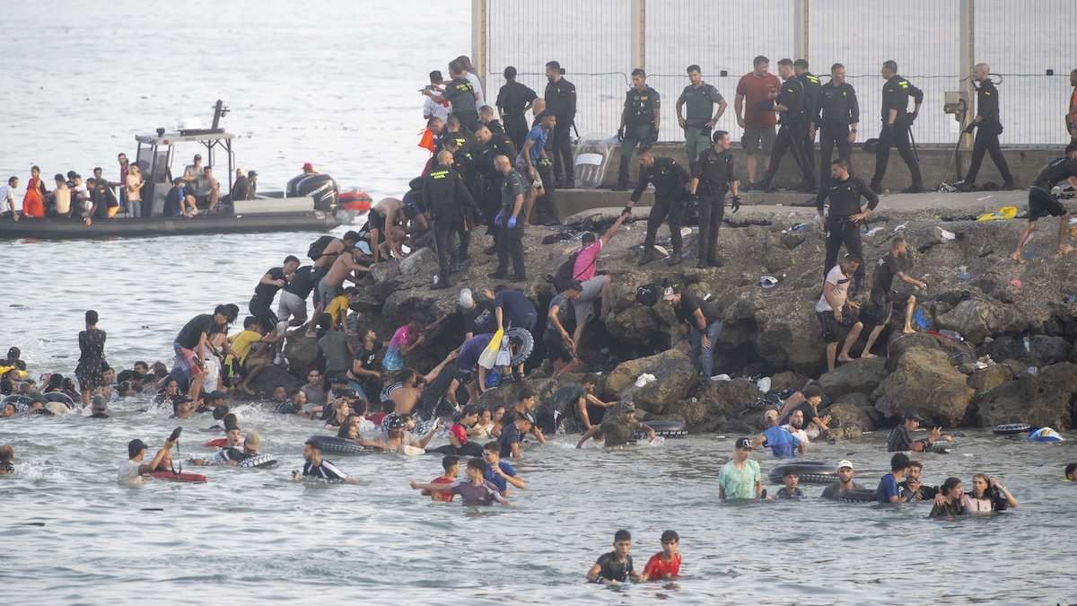 Dozens of migrants celebrate having crossed the border between Ceuta and Morocco in Madrid, Spain on July 31, 2026