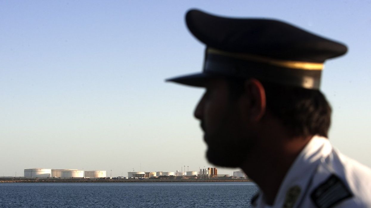 EDITORS' NOTE: Reuters and other foreign media are subject to Iranian restrictions on leaving the office to report, film or take pictures in Tehran. A security personnel looks on at oil docks at the port of Kalantari in the city of Chabahar, 300km (186 miles) east of the Strait of Hormuz January 17, 2012.