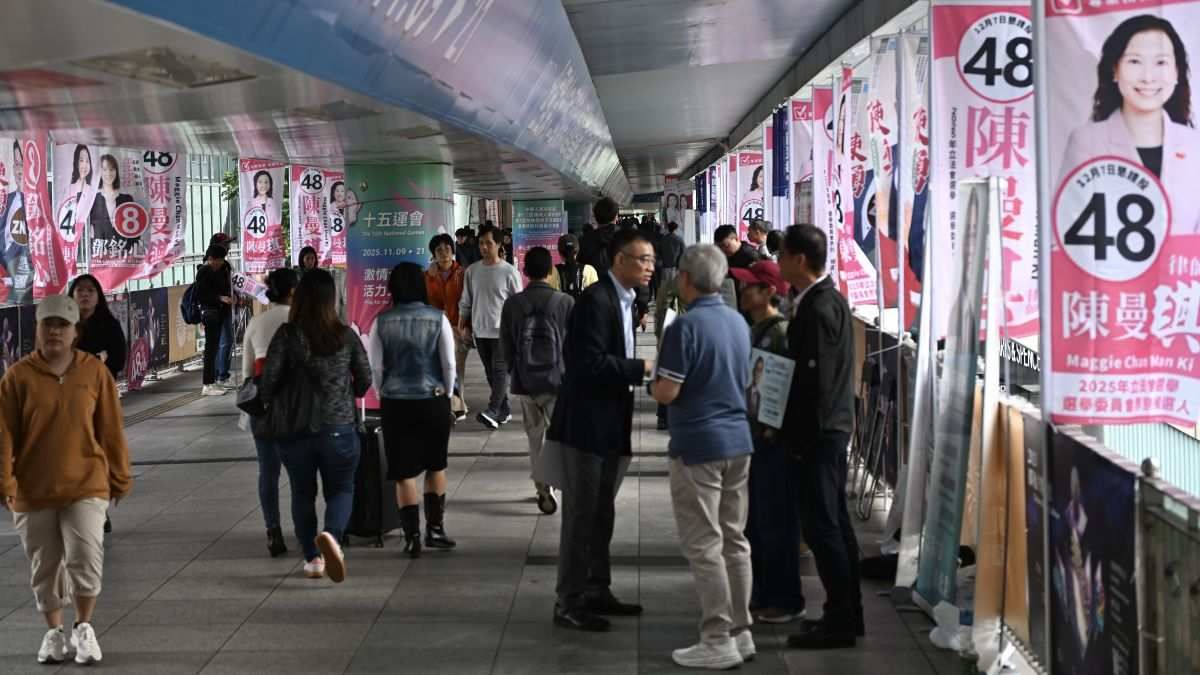 Election Commission candidates' campaign teams canvassing in permitted areas outside the polling station in Hong Kong on December 7, 2025.