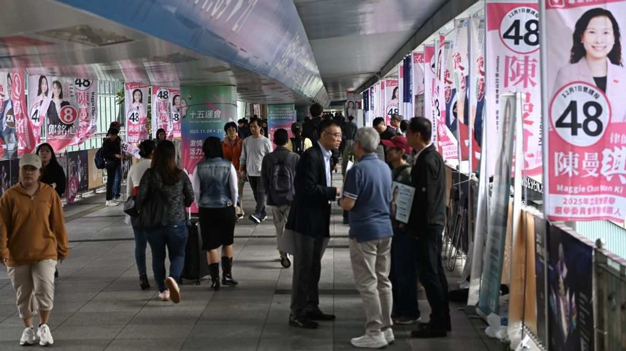 Election Commission candidates' campaign teams canvassing in permitted areas outside the polling station in Hong Kong on December 7, 2025.