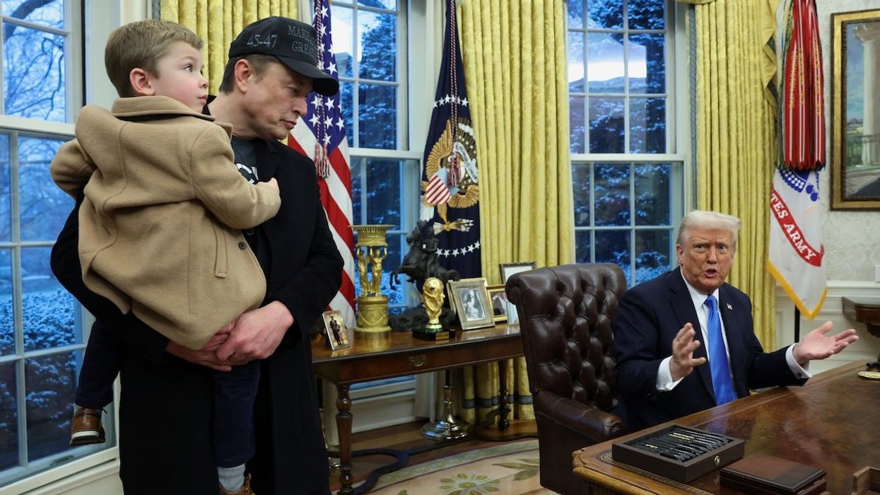 Elon Musk carries X Æ A-12 as President Donald Trump speaks in the Oval Office of the White House in Washington, D.C., on Feb. 11, 2025.