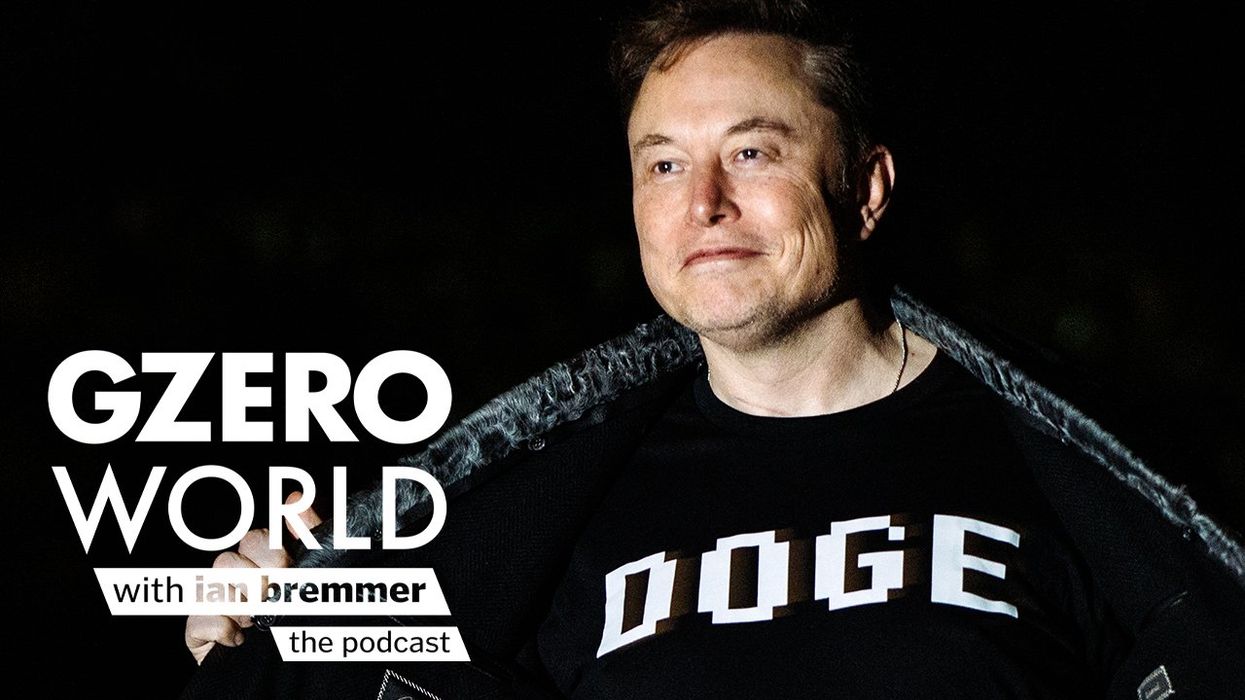 Elon Musk smiles while pulling open his jacket to reveal a black shirt with the word "DOGE" printed in bold letters. Text art reads "GZERO World with Ian Bremmer – the podcast."
