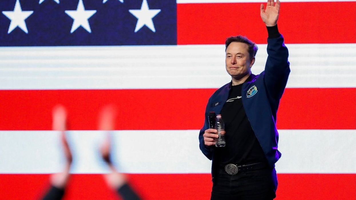 Elon Musk waves to the crowd as he exits the stage during a town hall on Sunday, March 30, 2025, at the KI Convention Center in Green Bay, Wis.