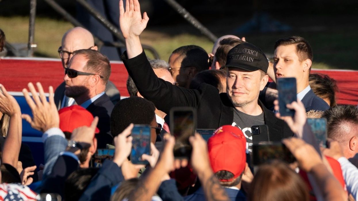 Elon Musk waves to the crowd before former President Donald Trump speaks at a campaign rally in Butler, Pa., on Oct. 5, 2024.