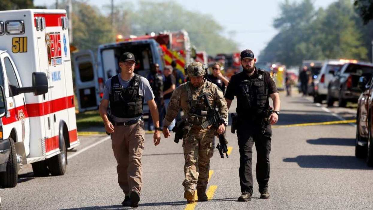 Emergency personnel work at the scene of a shooting which took place at the Church of Jesus Christ of Latter-day Saints, according to police, in Grand Blanc, Michigan, U.S., September 28, 2025.