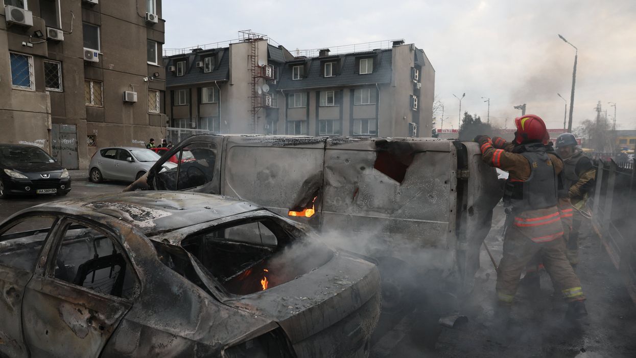 Emergency workers extinguish fire in vehicles at the site of a Russian missile strike, amid Russia?s attack on Ukraine, in Kyiv, Ukraine March 9, 2023.
