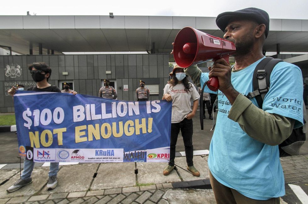 Environment activists march outside the British Embassy in Jakarta.