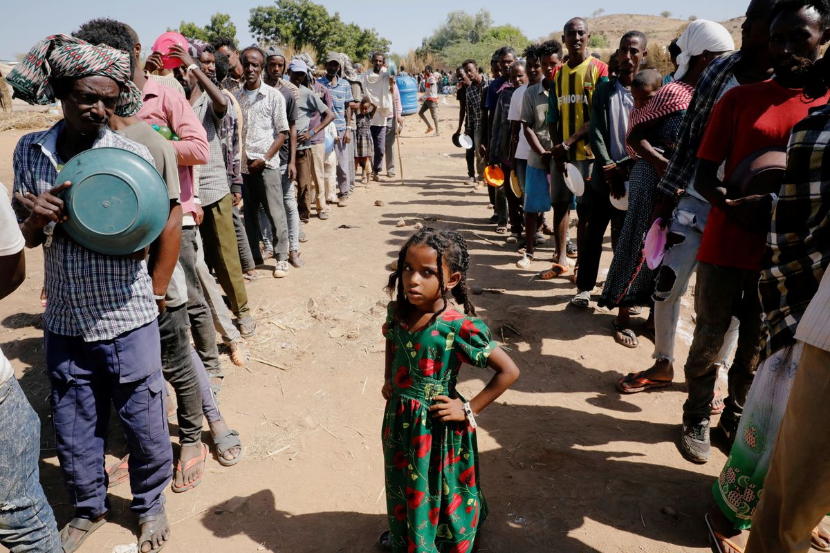 Ethiopian refugees wait in lines for a meal at the Um Rakuba refugee camp which houses Ethiopian refugees fleeing the fighting in the Tigray region, on the Sudan-Ethiopia border, Sudan, November 28, 2020.