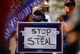 A supporter of U.S. President Donald Trump holds a sign during a “Stop the Steal” protest after the 2020 U.S. presidential election was called for Democratic candidate Joe Biden, in front of the Arizona State Capitol in Phoenix, Arizona