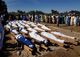 Men gather near dead bodies of people who were killed by militant attack, during a mass burial at Zabarmari, in the Jere local government area of Borno State, in northeast Nigeria, November 29, 2020