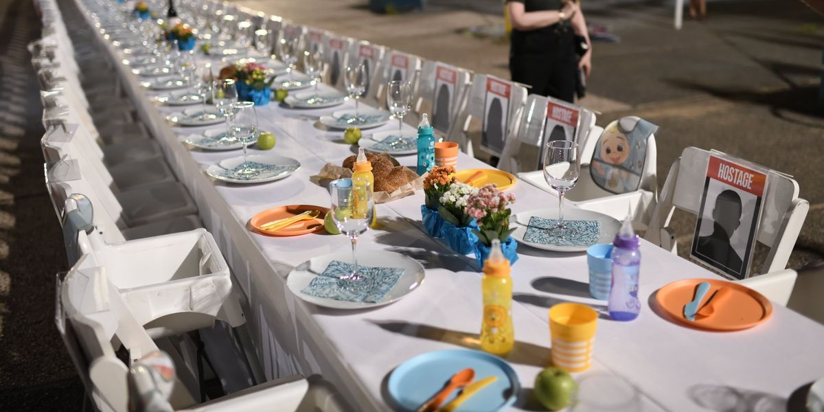 Families of Israelis held hostage by Hamas militants in Gaza set a Shabbat table with more than 200 empty seats for them at the "Hostages Square" outside the Art Museum of Tel Aviv, on Oct. 20, 2023. 