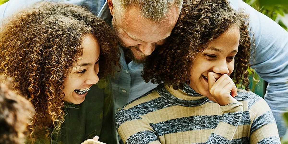 Father with his two daughters smiling