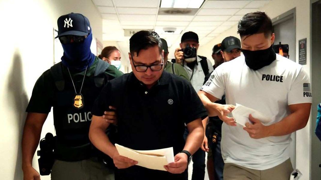 Federal officers detain a man at the Immigration court office areas at the Jakob Javits Federal Builing in Lower Manhattan on July 28,2025 in New York City.