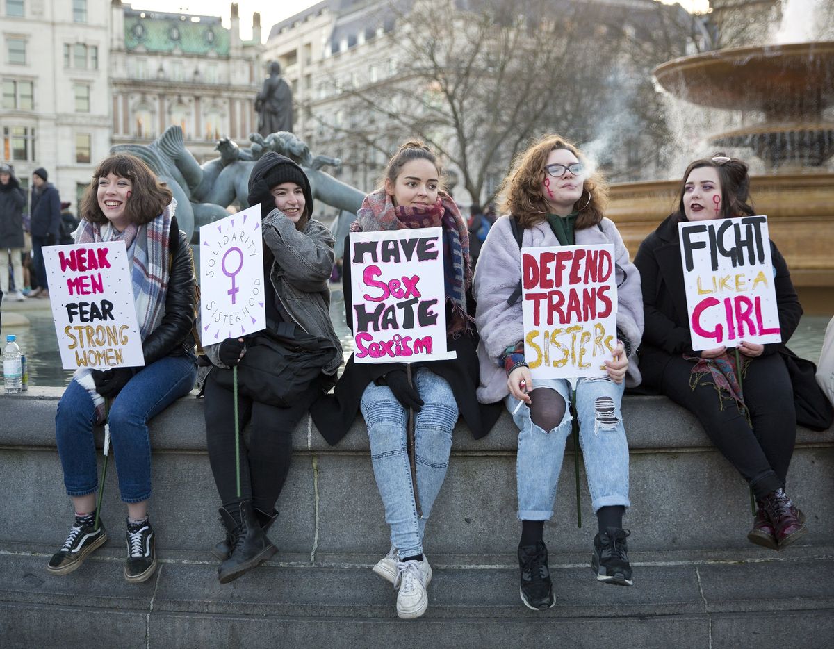 Feminist protestors holding signs on International Women's Day.