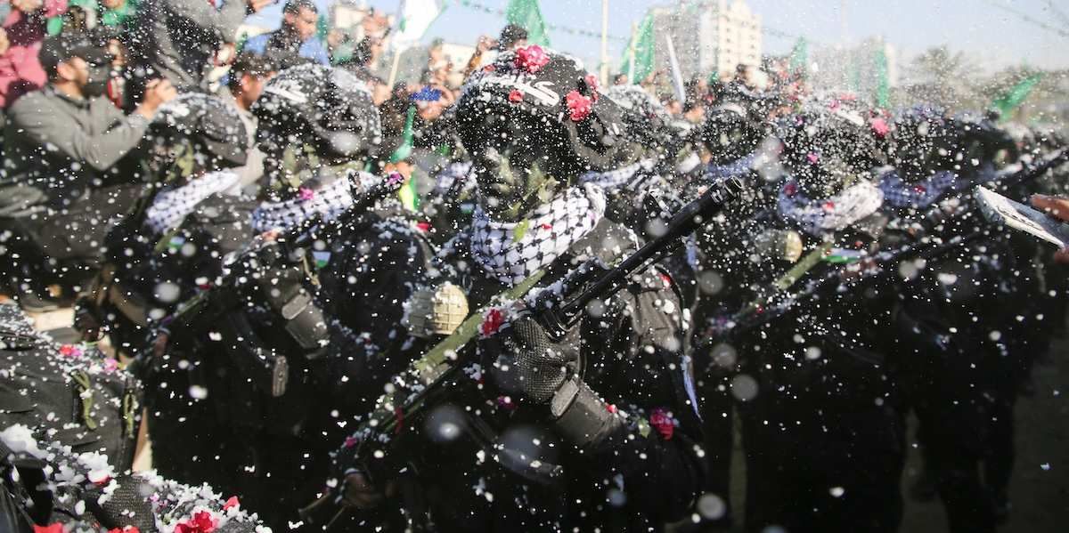​Fighters of the Qassam Brigades, the armed wing of the Palestinian Islamist Hamas movement, attend a rally marking the 35th anniversary of the group's foundation in Gaza City on December 14, 2022. 