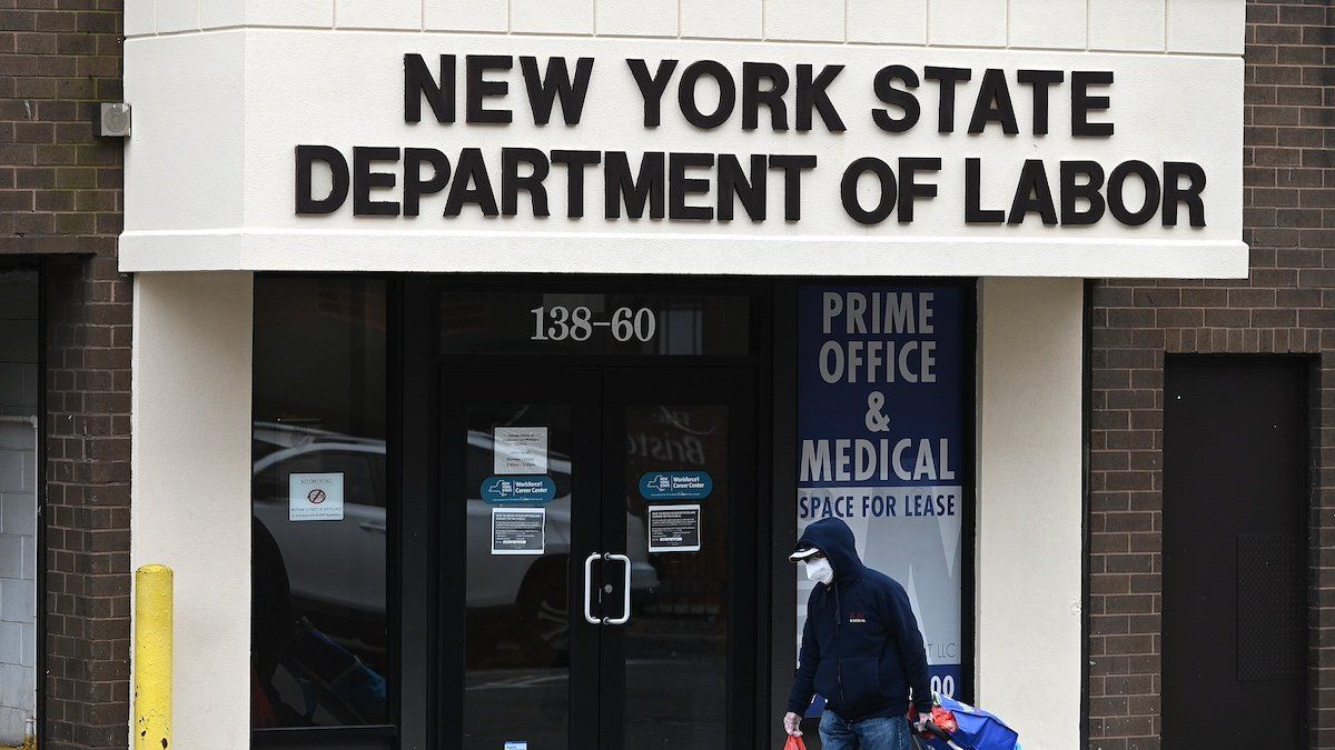 ​FILE PHOTO: A man walks past the offices of the New York State Department of Labor in the Queens borough of New York City, NY, January 8, 2021.