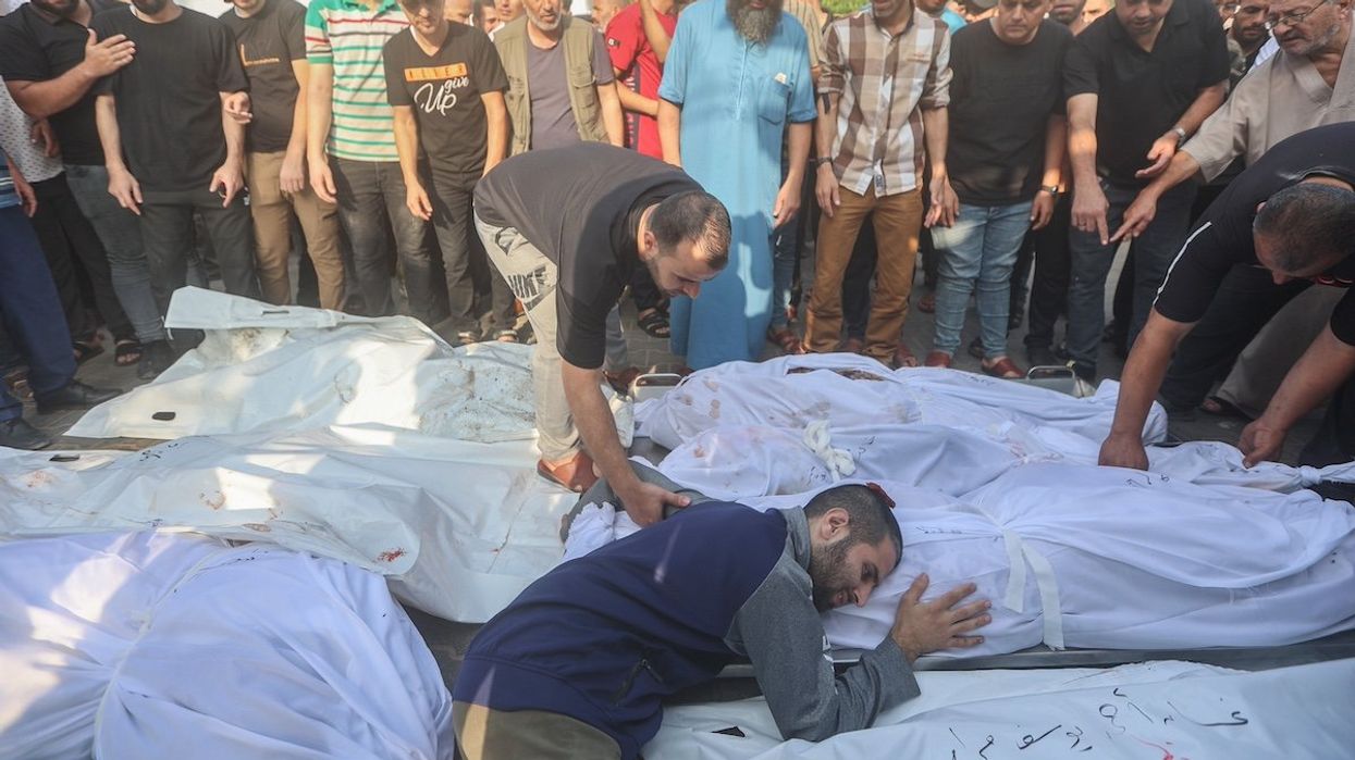 FILE PHOTO: A Palestinian man cries next to bodies of her family members who died following Israeli strikes earlier, during their funeral in Khan Yunis in the southern Gaza Strip.