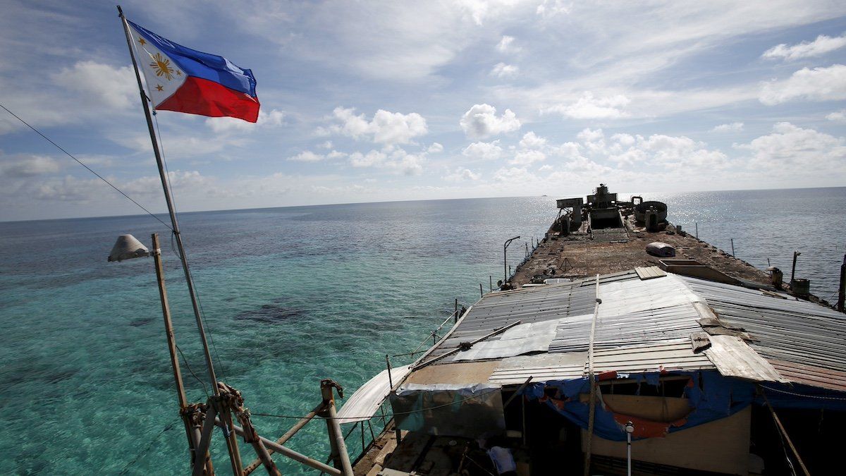 FILE PHOTO - A Philippine flag flutters from BRP Sierra Madre, a dilapidated Philippine Navy ship that has been aground since 1999 and became a Philippine military detachment on the disputed Second Thomas Shoal, part of the Spratly Islands, in the South China Sea March 29, 2014. 
