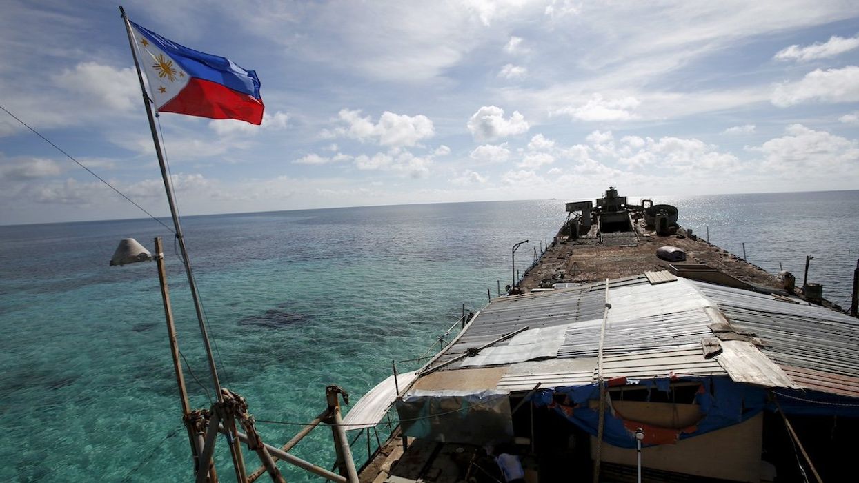 FILE PHOTO - A Philippine flag flutters from BRP Sierra Madre, a dilapidated Philippine Navy ship that has been aground since 1999 and became a Philippine military detachment on the disputed Second Thomas Shoal, part of the Spratly Islands, in the South China Sea March 29, 2014.