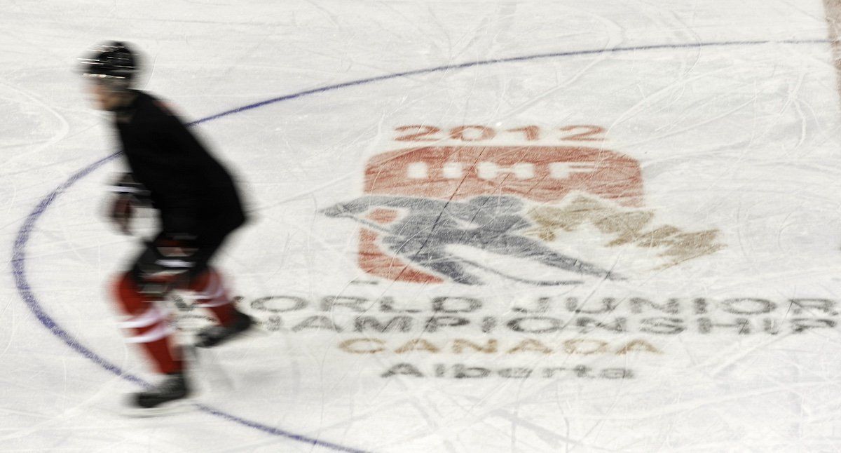 ​FILE PHOTO: A Team Canada player skates past the tournament logo during practice in Edmonton December 25, 2011. Team Canada will play in the upcoming World Junior Hockey tournament in Calgary and Edmonton which takes place from December 26 to January 5, 2012.