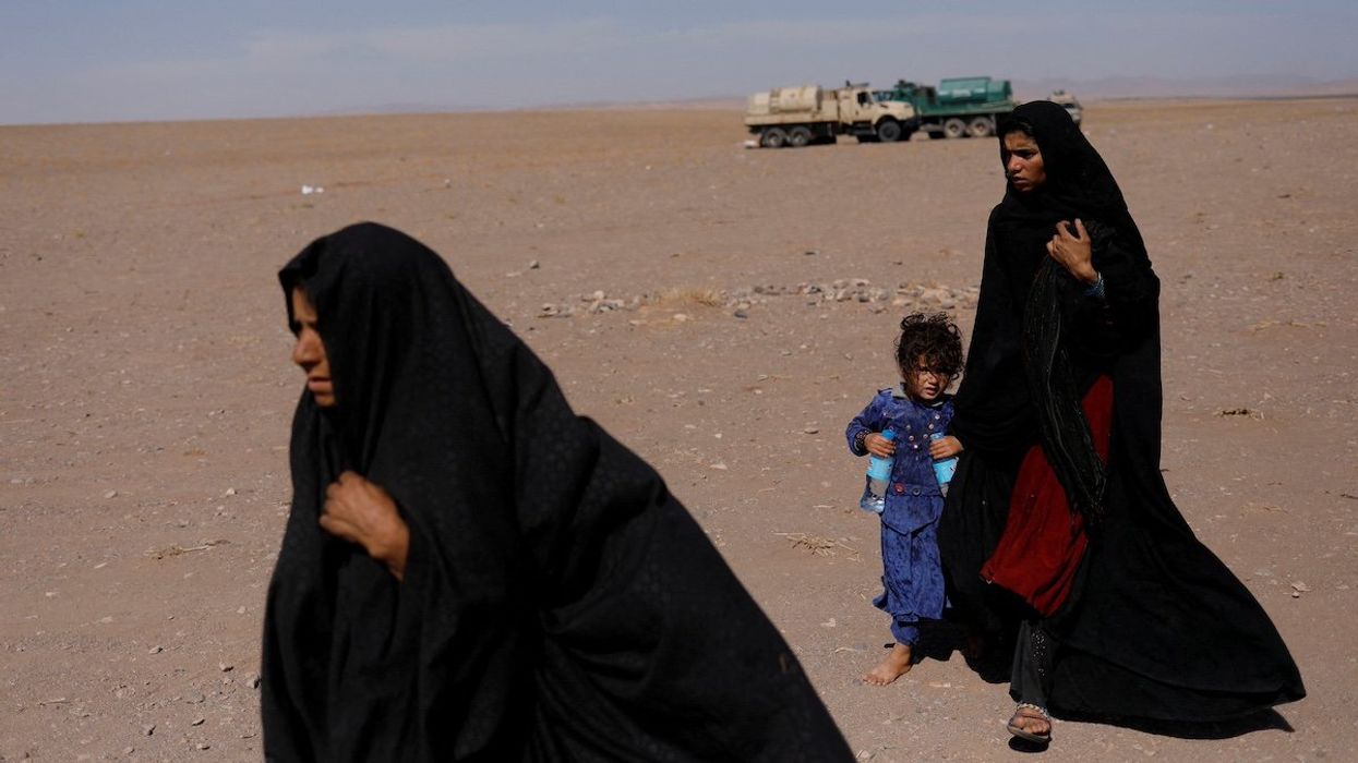 FILE PHOTO: Afghan women walk after the recent earthquake in the district of Zinda Jan, in Herat, Afghanistan October 10, 2023.