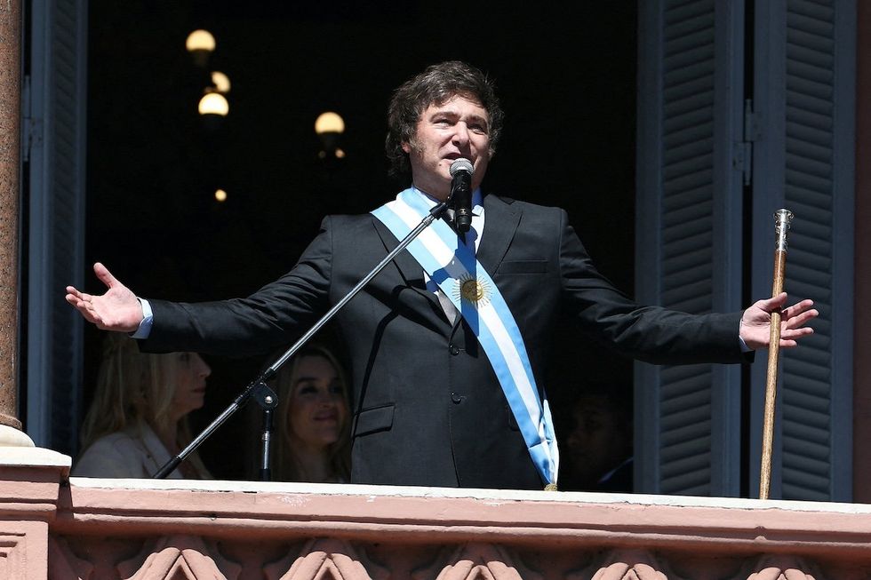 FILE PHOTO: Argentina's President Javier Milei addresses supporters from the Casa Rosada balcony, as his sister Karina Milei and his partner Fatima Florez look on, after his swearing-in ceremony, in Buenos Aires, Argentina December 10, 2023. 