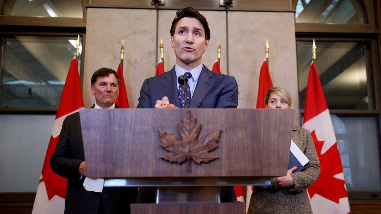 FILE PHOTO: Canada's Prime Minister Justin Trudeau, with Minister of Foreign Affairs Melanie Joly, and Minister of Public Safety, Democratic Institutions and Intergovernmental Affairs Dominic LeBlanc, takes part in a press conference about the Royal Canadian Mounted Police's investigation into "violent criminal activity in Canada with connections to India", on Parliament Hill in Ottawa, Ontario, Canada October 14, 2024.