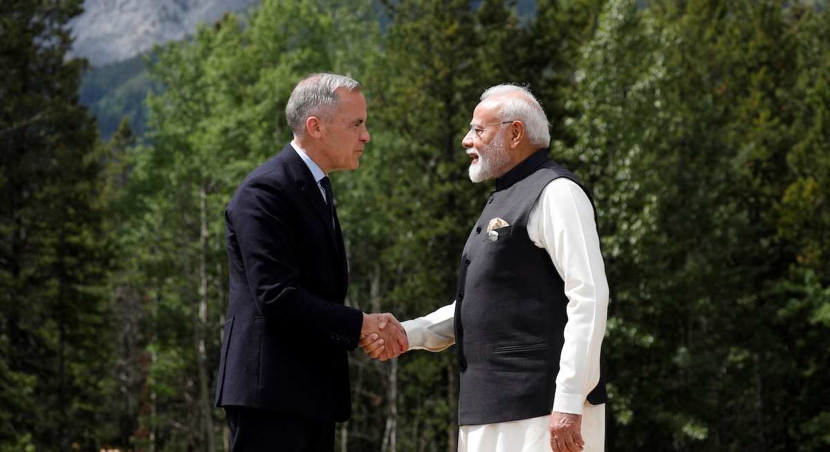 ​FILE PHOTO: Canadian Prime Minister Mark Carney and India's Prime Minister Narendra Modi shake hands before posing for a photo during the G7 Leaders' Summit in Kananaskis, in Alberta, Canada, June 17, 2025. 