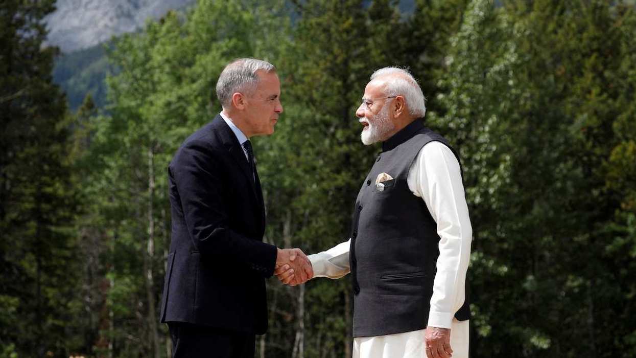 FILE PHOTO: Canadian Prime Minister Mark Carney and India's Prime Minister Narendra Modi shake hands before posing for a photo during the G7 Leaders' Summit in Kananaskis, in Alberta, Canada, June 17, 2025.
