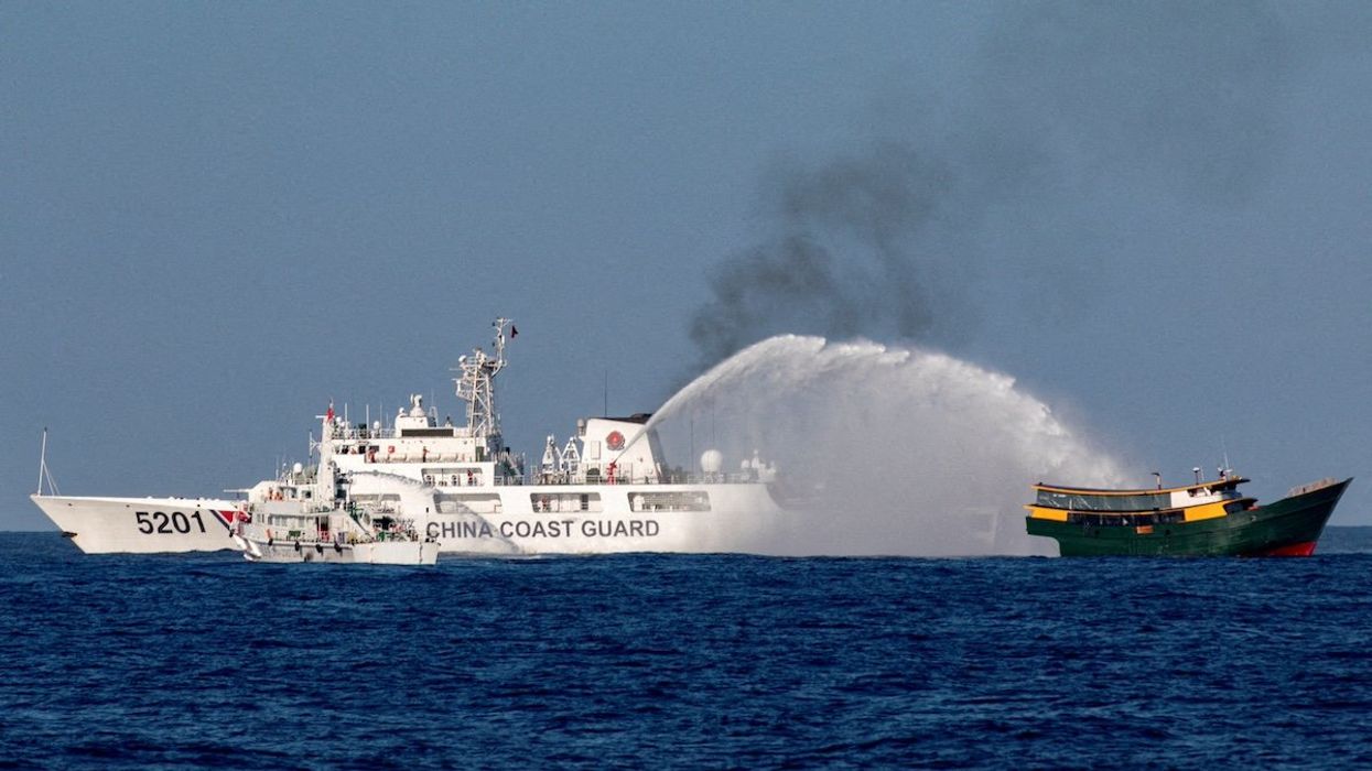 FILE PHOTO: Chinese Coast Guard vessels fire water cannons towards a Philippine resupply vessel Unaizah on May 4 as it made its way to the Second Thomas Shoal in the South China Sea, March 5, 2024.