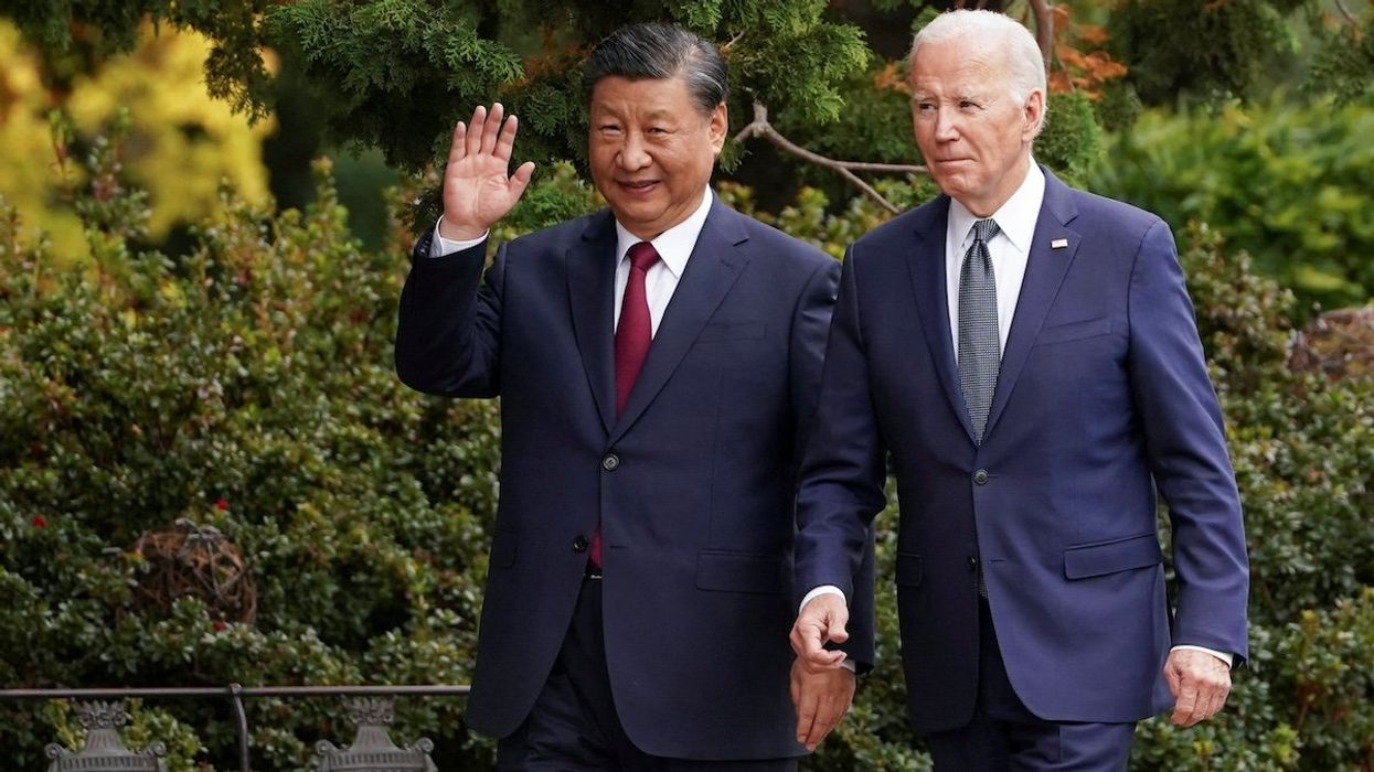 FILE PHOTO: Chinese President Xi Jinping waves as he walks with U.S. President Joe Biden at Filoli estate on the sidelines of the Asia-Pacific Economic Cooperation (APEC) summit, in Woodside, California, U.S., November 15, 2023.