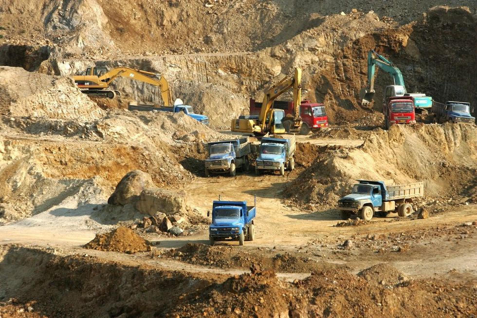 FILE PHOTO: Excavators load trucks with rare earth at a mine in Mojiang Hani Autonomous County, Simao city, southwest Chinas Yunnan province, 18 March 2008.