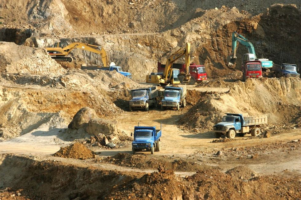 FILE PHOTO: Excavators load trucks with rare earth at a mine in Mojiang Hani Autonomous County, Simao city, southwest Chinas Yunnan province, 18 March 2008. 