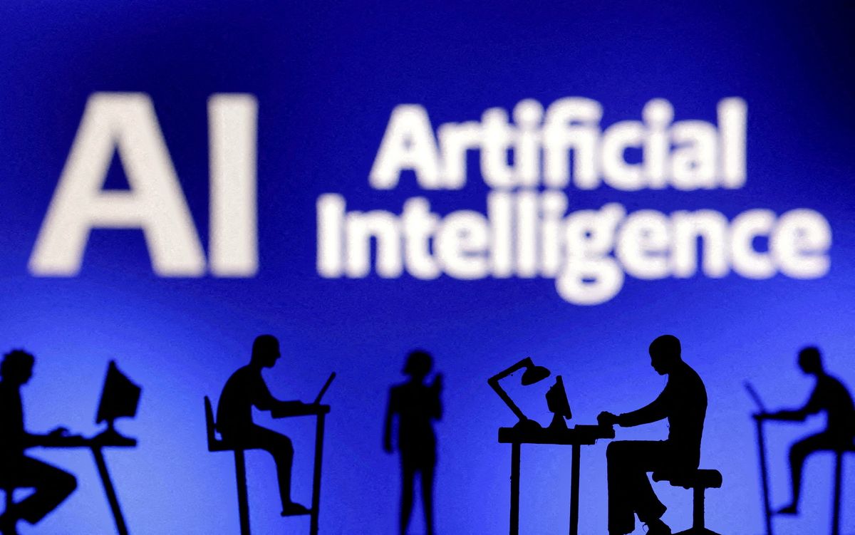 ​FILE PHOTO: Figurines with computers and smartphones are seen in front of the words "Artificial Intelligence AI" in this illustration taken, February 19, 2024. 