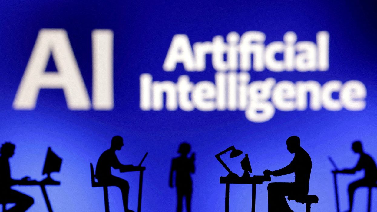 FILE PHOTO: Figurines with computers and smartphones are seen in front of the words "Artificial Intelligence AI" in this illustration taken, February 19, 2024.