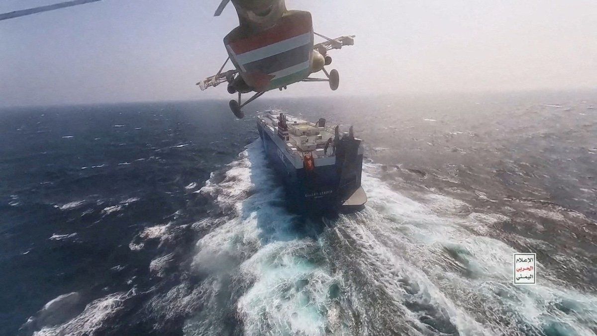 FILE PHOTO: Houthi military helicopter flies over the Galaxy Leader cargo ship in the Red Sea in this photo released November 20, 2023.