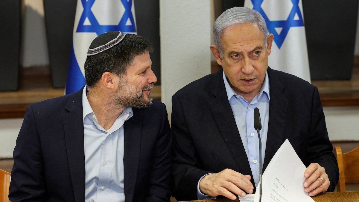 FILE PHOTO: Israeli Prime Minister Benjamin Netanyahu speaks with Minister of Finance Bezalel Smotrich during the weekly cabinet meeting at the Defence Ministry in Tel Aviv, Israel, January 7, 2024. REUTERS/Ronen Zvulun/Pool/File Photo