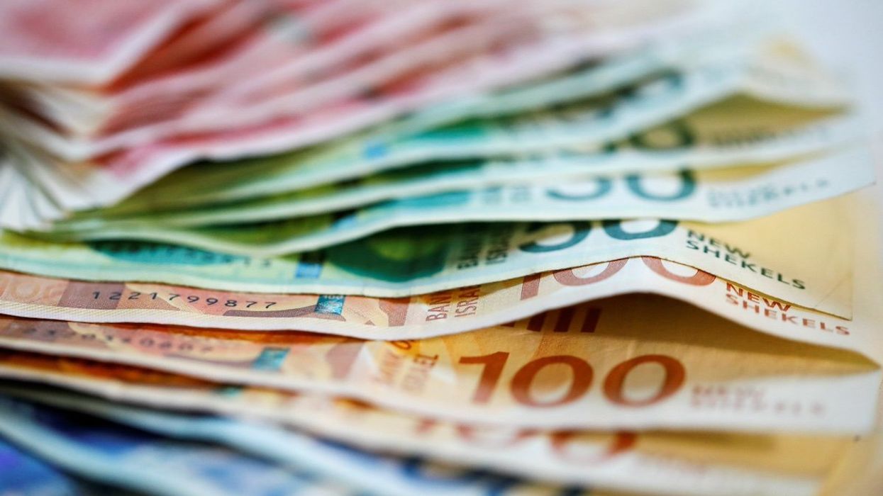 FILE PHOTO: New Israeli Shekel banknotes are seen in this picture illustration taken November 9, 2021.