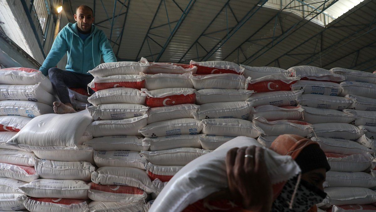 FILE PHOTO: Palestinian employees at the United Nations Relief and Works Agency for Palestinian Refugees (UNRWA) prepare food aid rations for refugees, in Gaza city on January 19, 2022