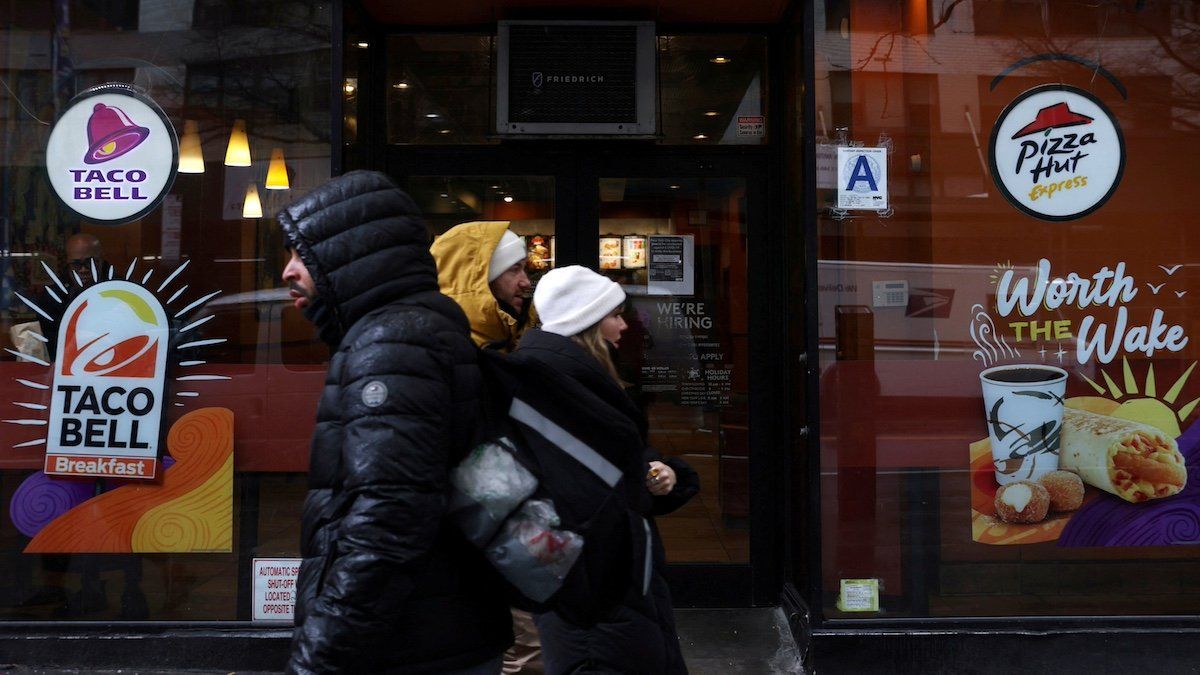 ​FILE PHOTO: People walk by a Taco Bell and Pizza Hut, subsidiaries of Yum! Brands, Inc. in Manhattan, New York City, U.S., February 7, 2022. 